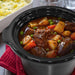 Removable stoneware slides right out of the base for easy transport to the table or storage in the fridge. Showing Elite Gourmet Slow Cooker's stoneware part with curry.