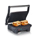 Nonstick Electric Panini Grill. Open position and toasting panini sandwiches.